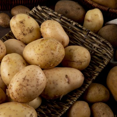 side view raw potatoes on a dish